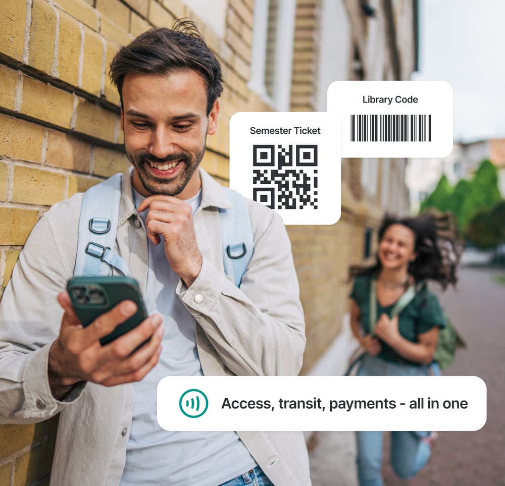 Smiling students walking on a university campus, one holding a smartphone displaying Studo all-in-one digital ID with a QR code for semester ticket identification and a barcode for library access